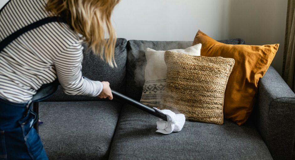 person cleaning sofa