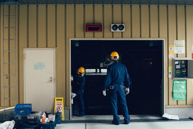 persons repairing garage door