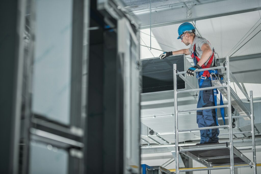 construction-worker-checking-newly-installed-air-ventilation