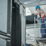 construction-worker-checking-newly-installed-air-ventilation