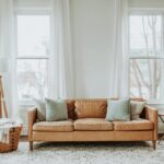 white-and-brown-sofa-chair-near-white-window-curtain