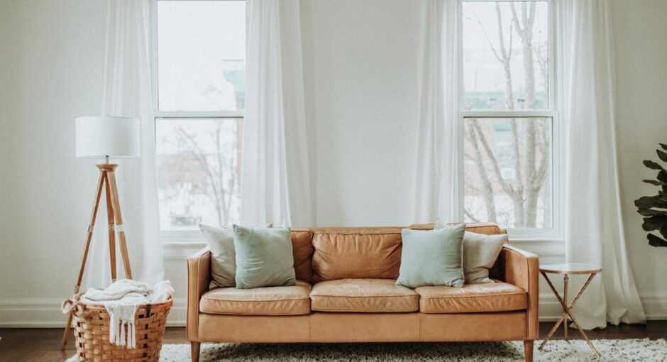 white-and-brown-sofa-chair-near-white-window-curtain