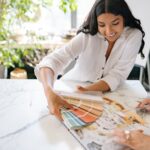 woman-holding-a-palette-with-color-samples-and-smiling