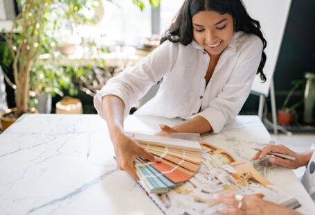 woman-holding-a-palette-with-color-samples-and-smiling